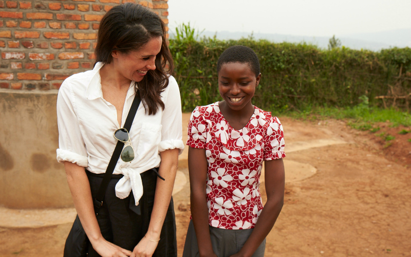 Meghan Markle laughs with young girl 
