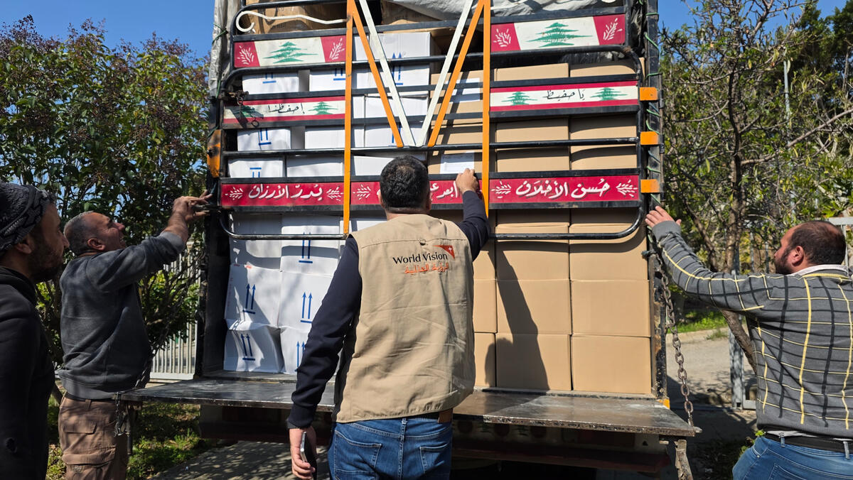 World Vision staff in Lebanon unload a lorry of supplies.