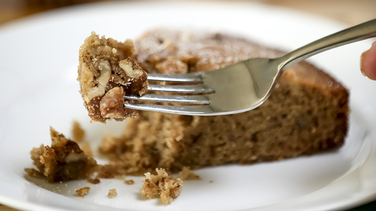 A fork lifts from a slice of Armenian honey cake