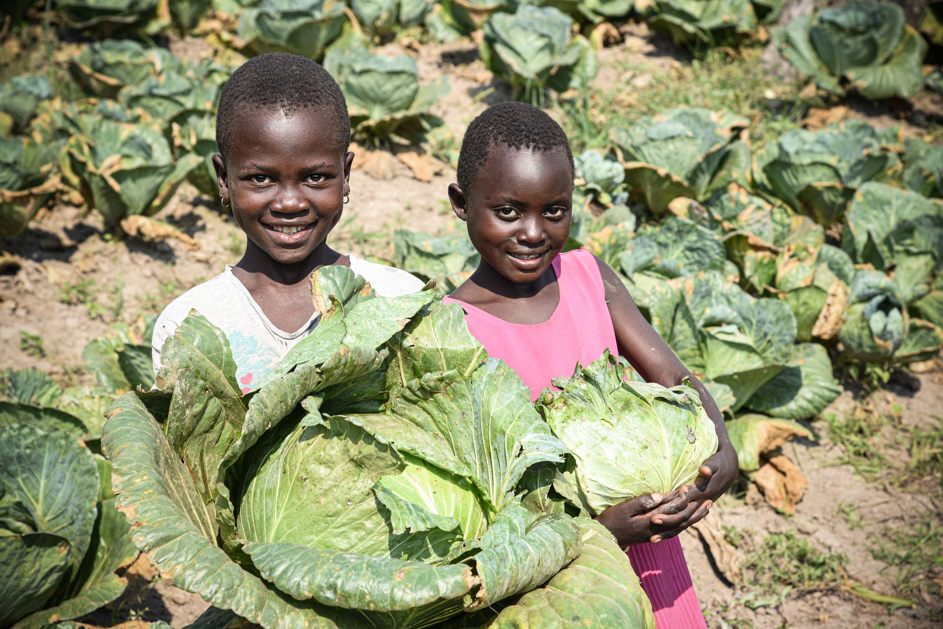 Estha and her friend in their family field.