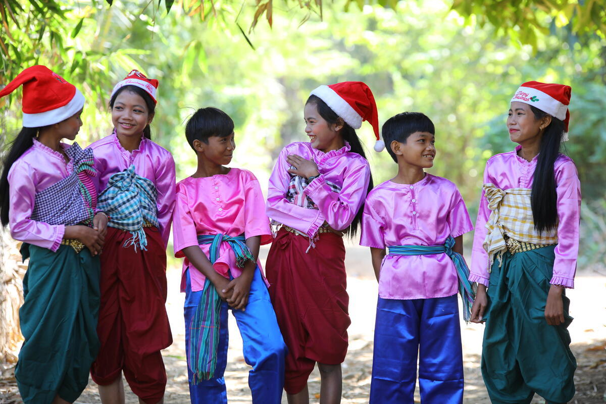 A group of children wearing Christmas hats in Cambodia.