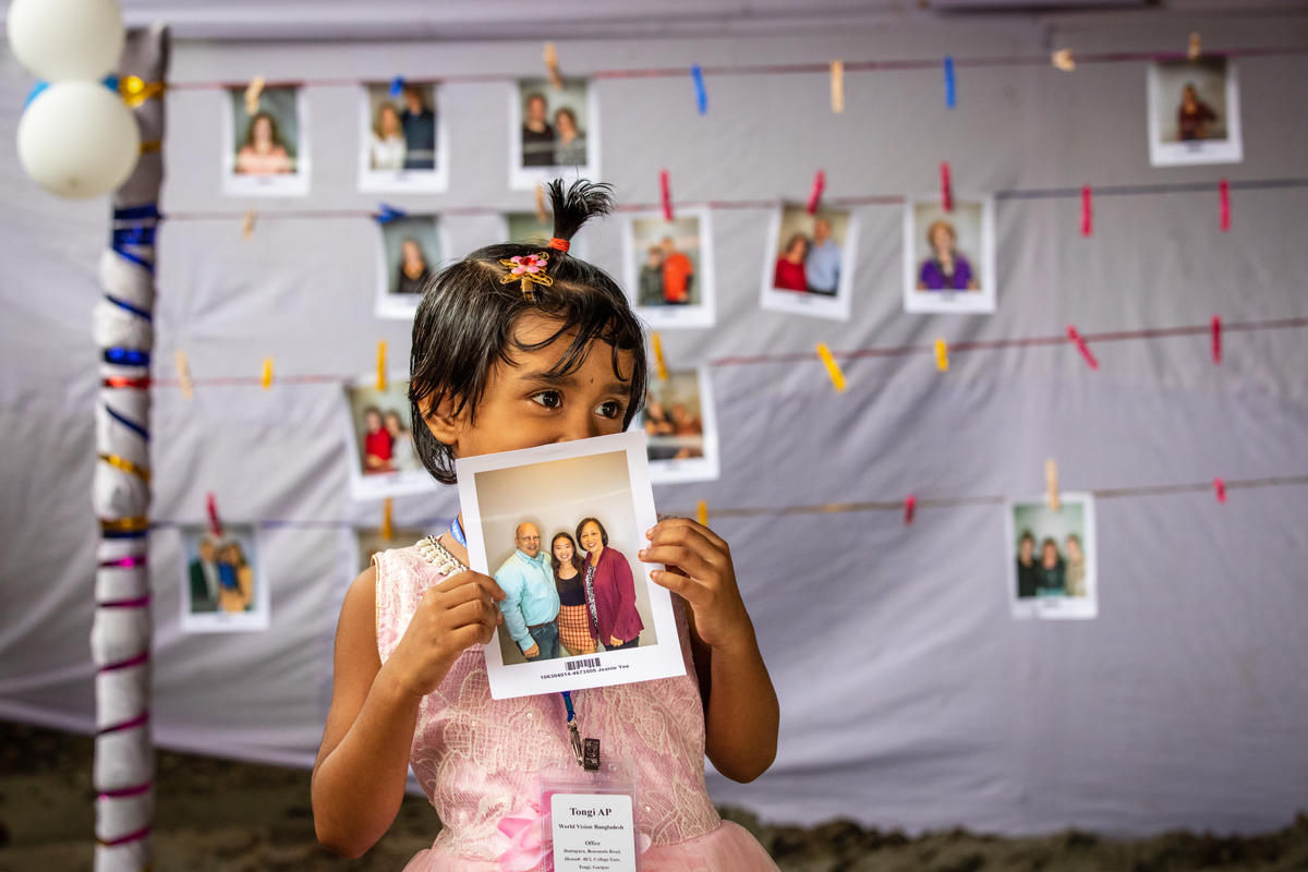 Milli with a photo of her chosen sponsors
