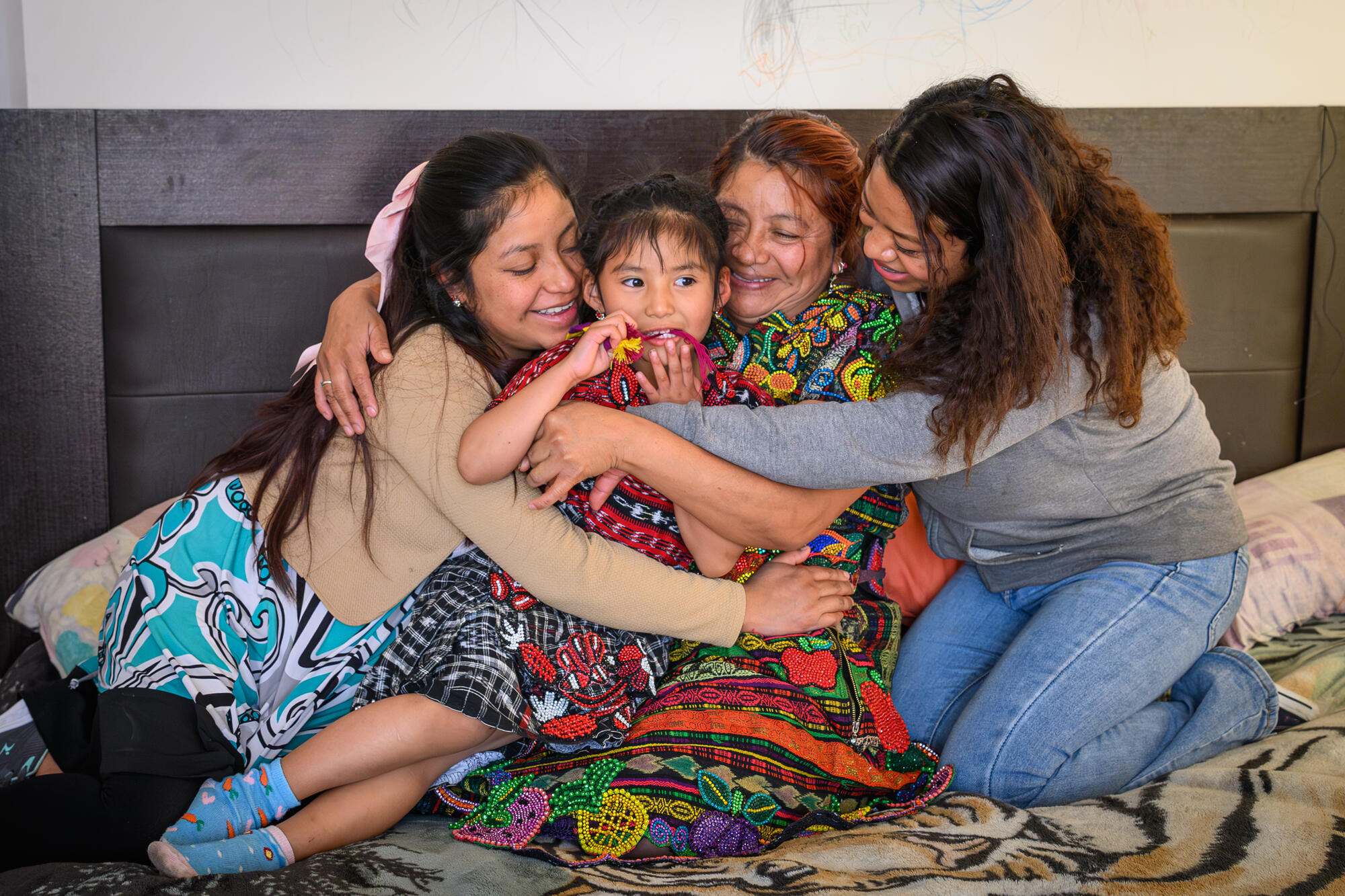 Group hub between a woman and her three daughters in Guatemala