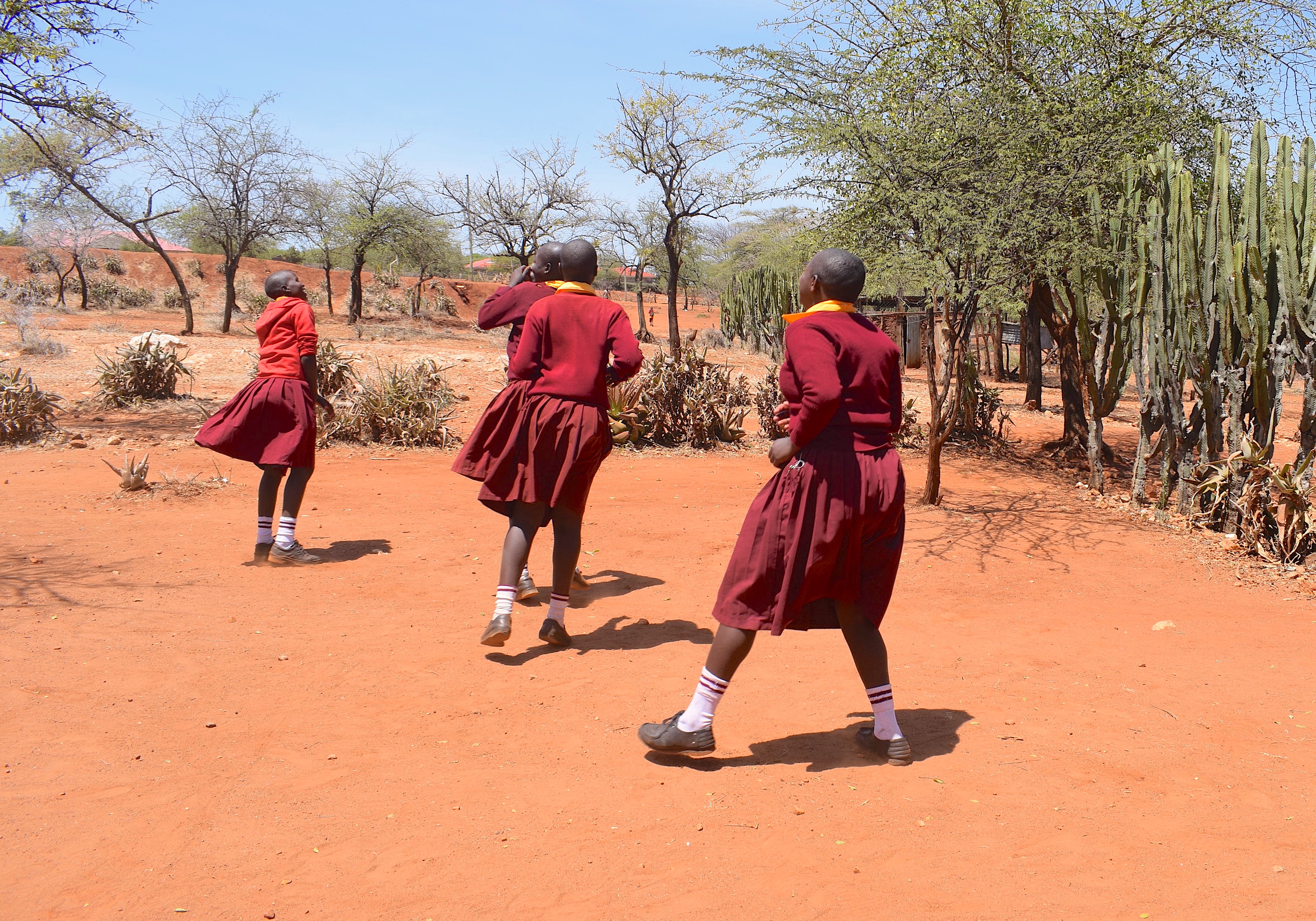 Three teenage girls playing happily outside