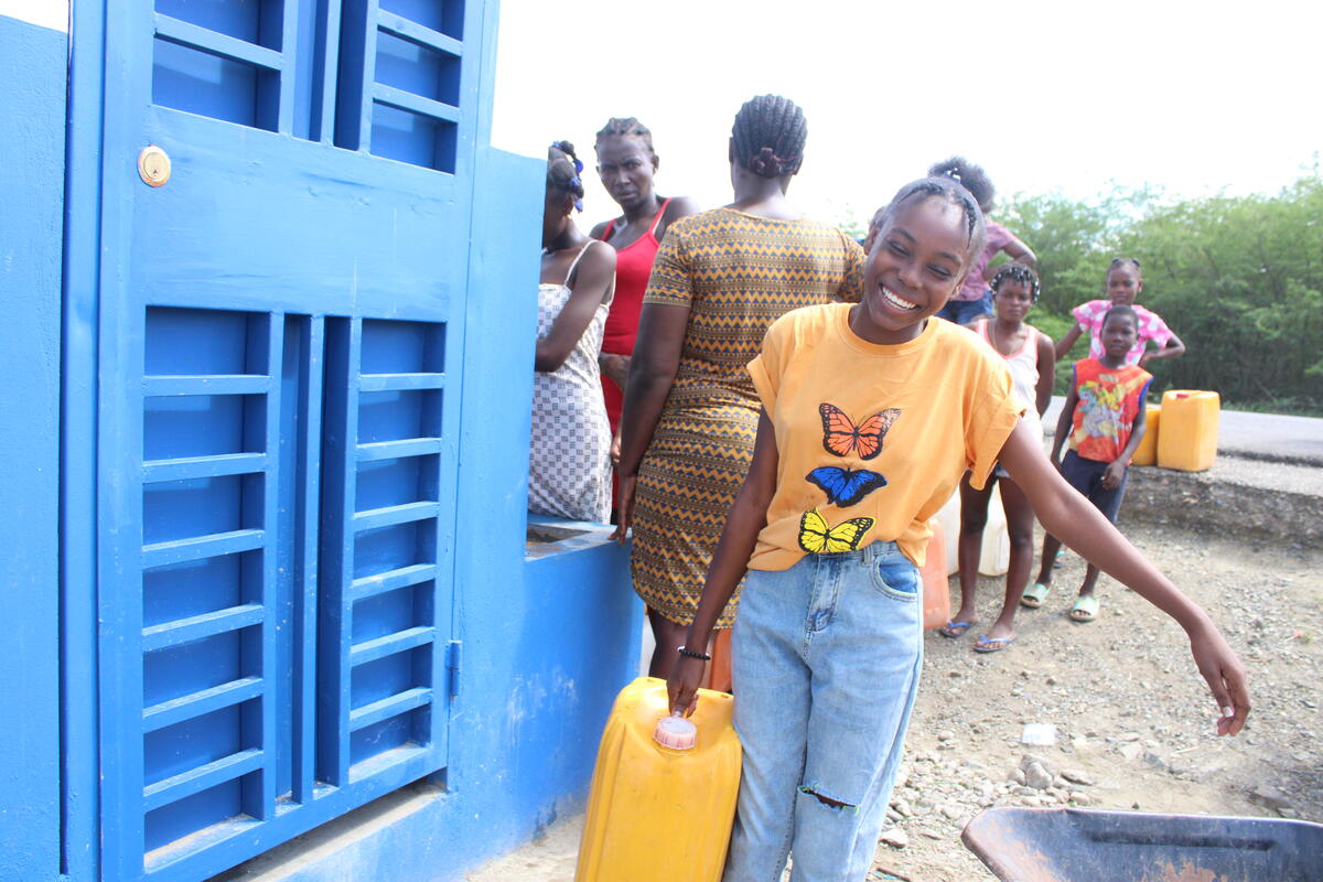  A young lady carries a water container in Haiti
