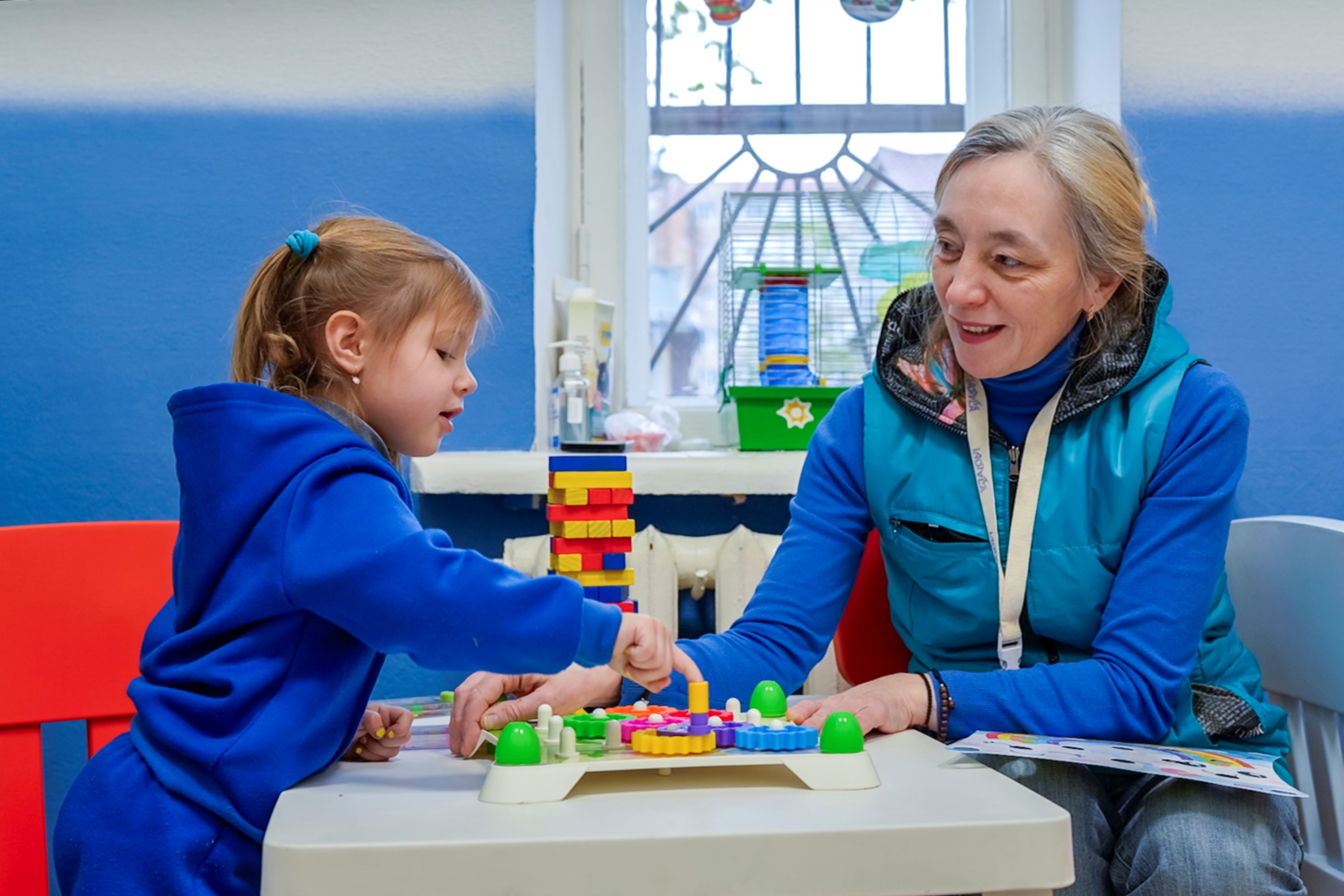 Alexandra, 2, plays and interacts with volunteer Lulia