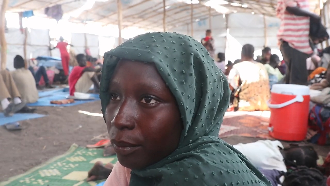 Young Sudanese refugee woman sitting in a camp, South Sudan