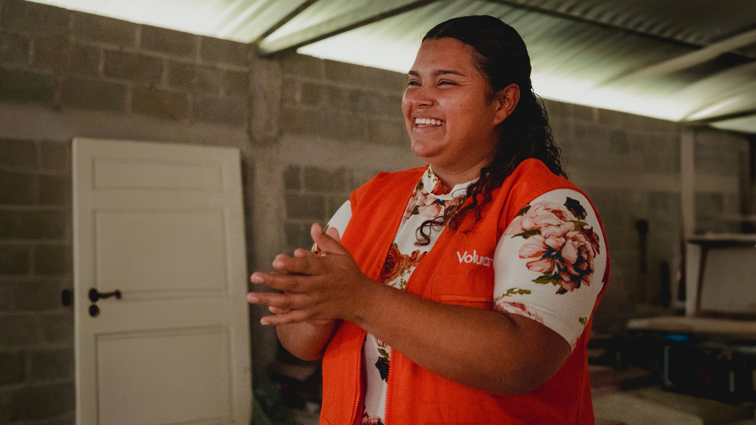 Lisbeth is pictured in her bright orange World Vision vest at a Youth Ready training session