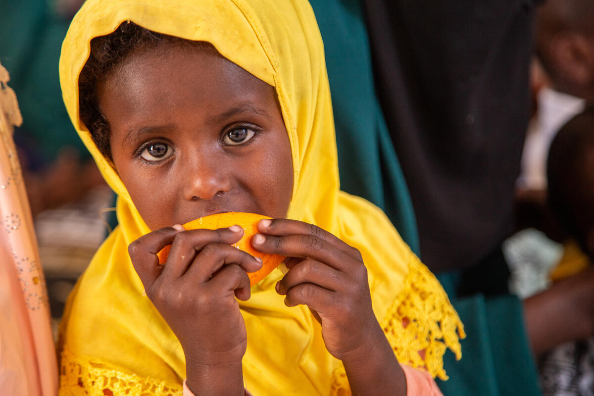Somali girl eating an orange