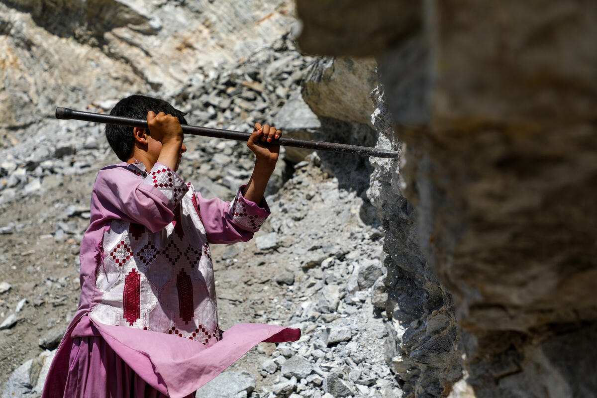 Boy from Afghanistan digging rock
