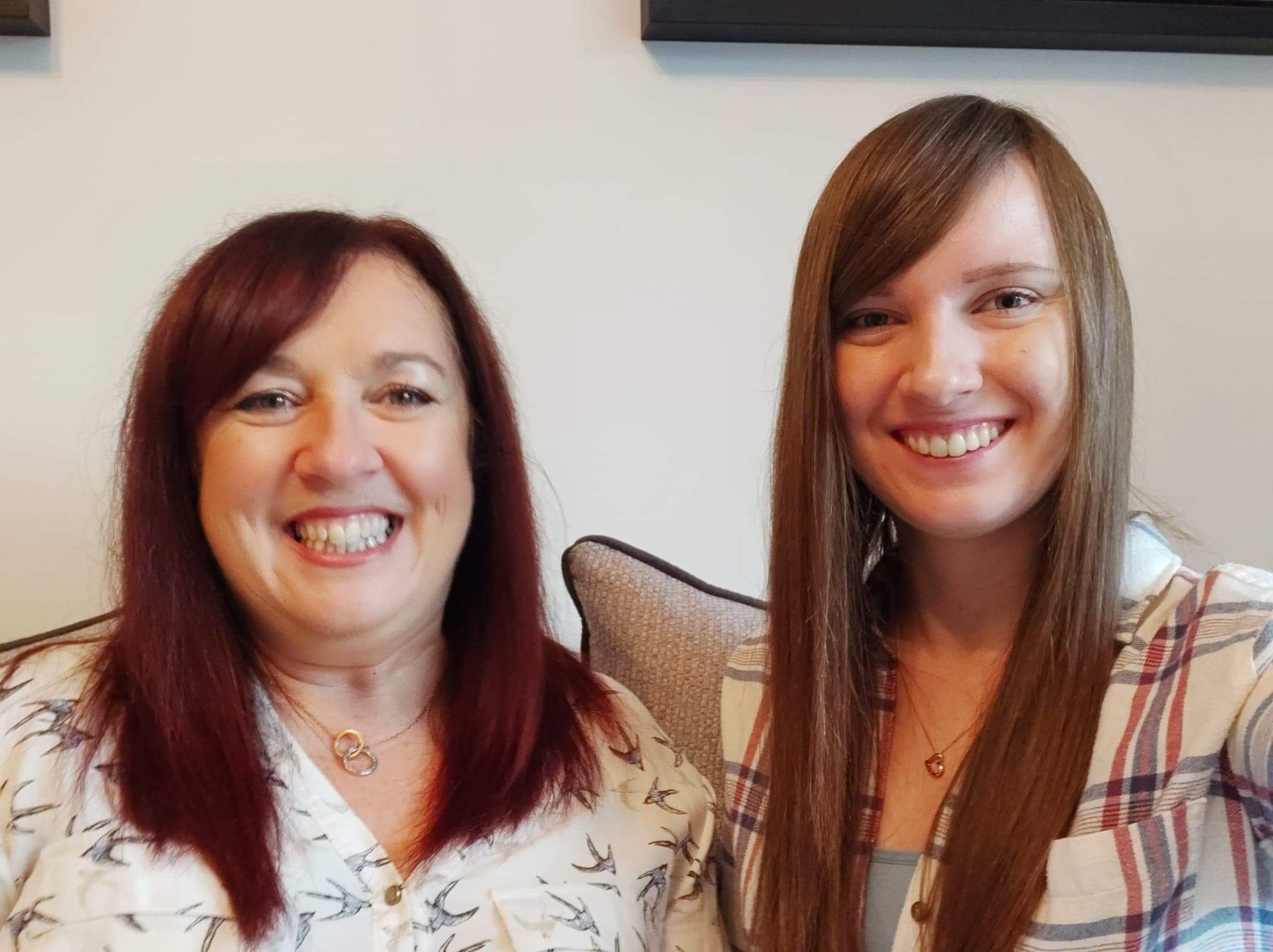 Caroline and Lizzie McLeod smile as they wait for their call with sponsored child Odalis