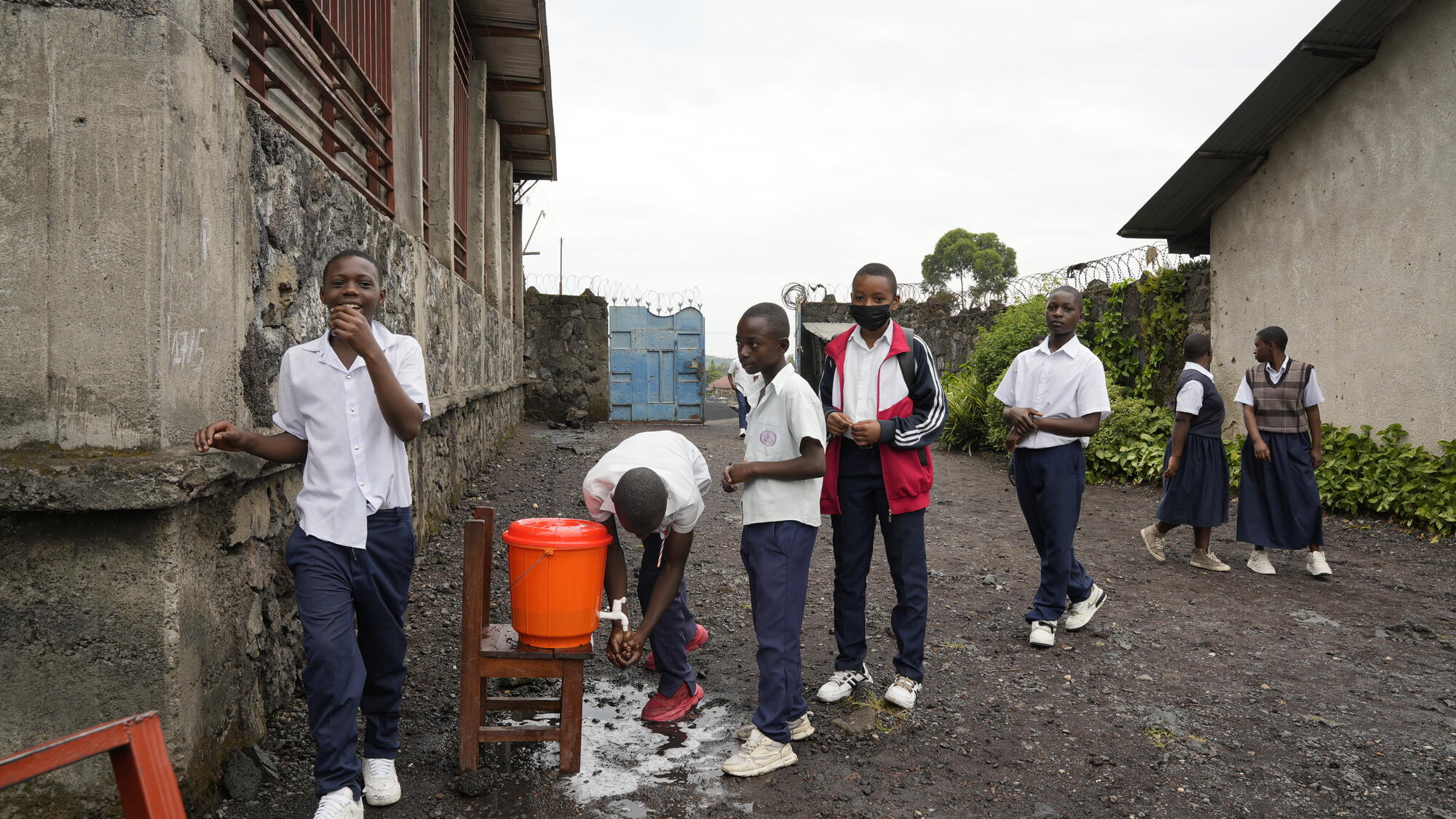 Children in DRC queue to wash their hands at school.