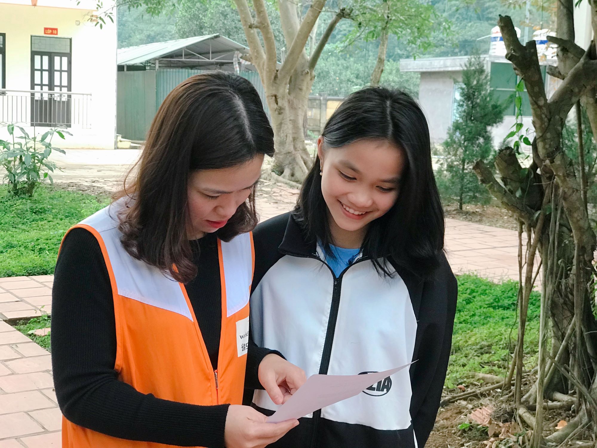 Sponsored girl with World Vision worker