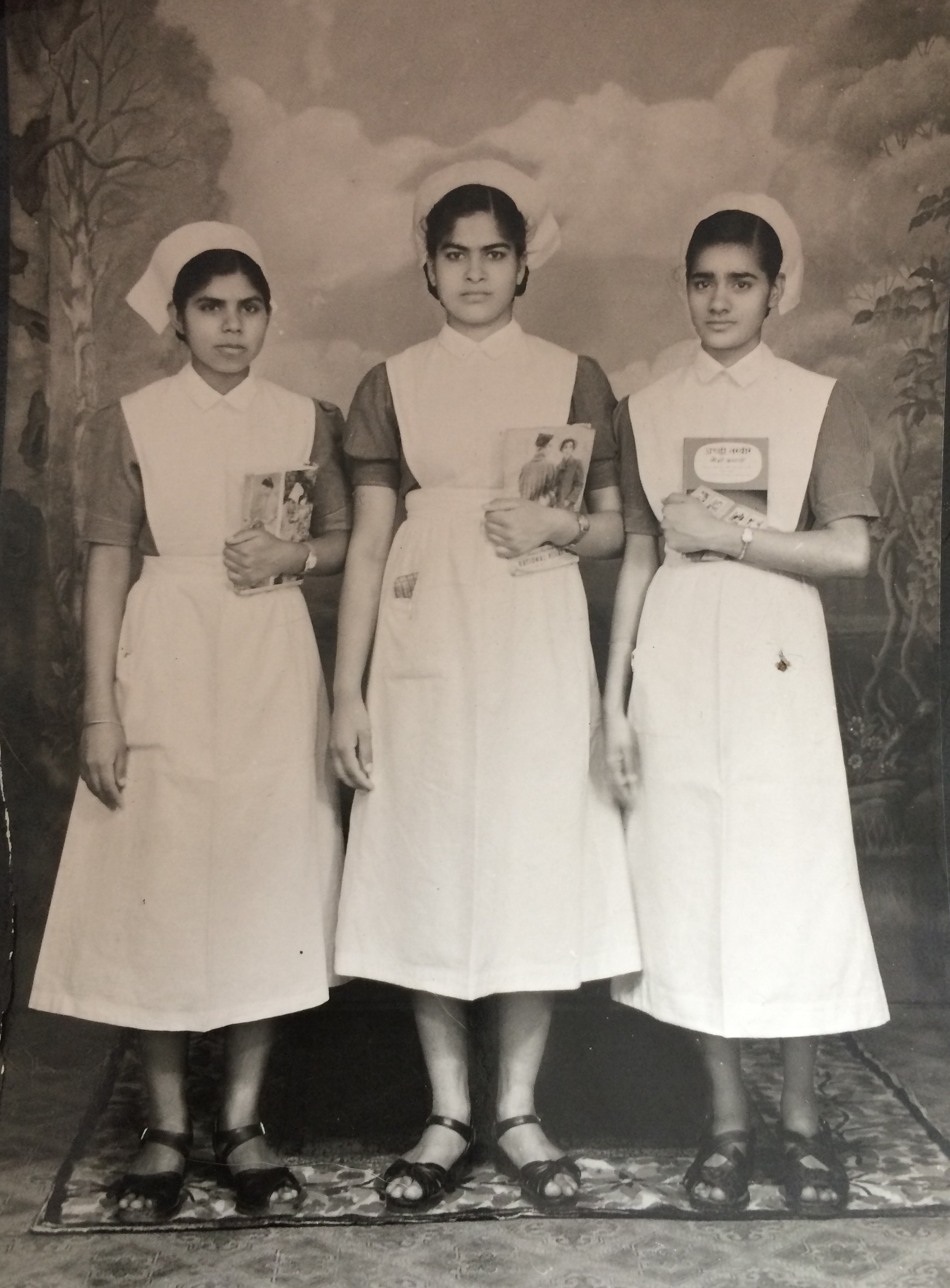 Motia with two colleagues in full nurses uniform