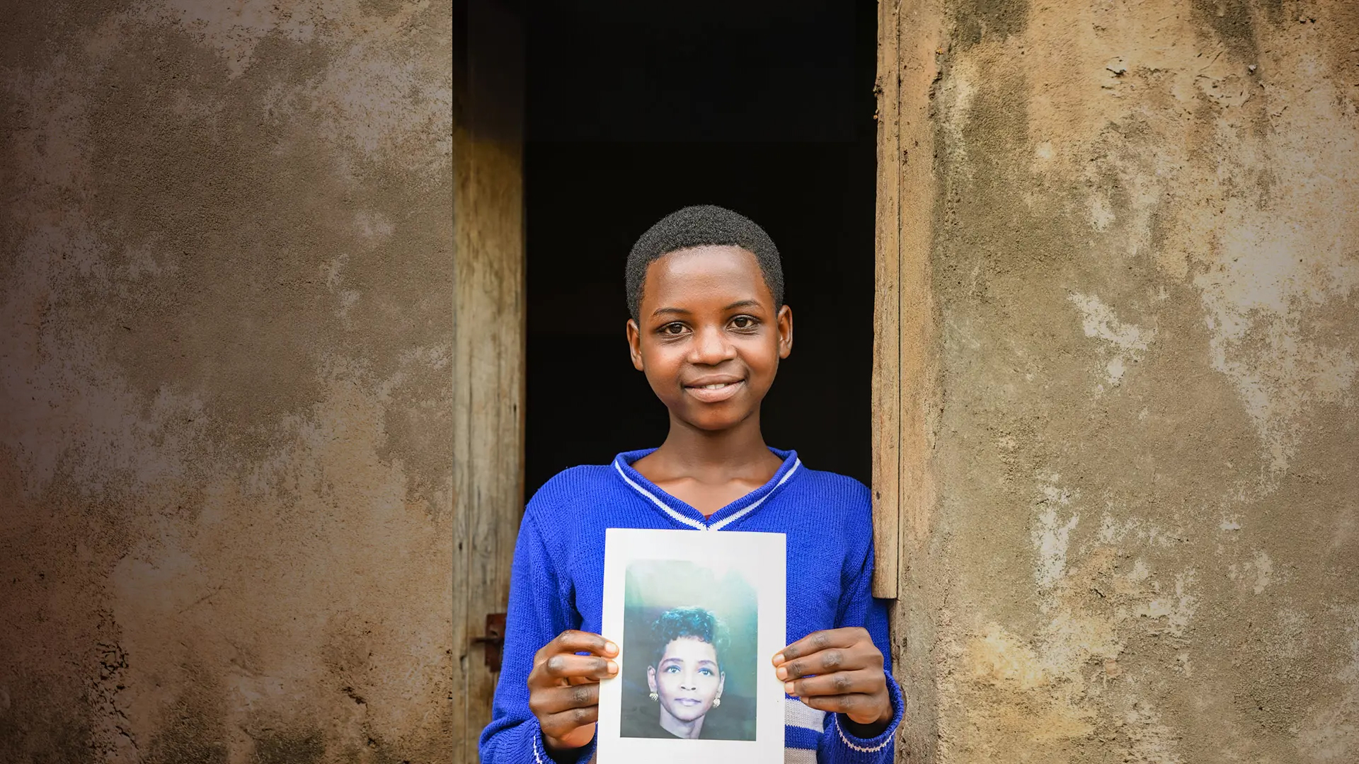 Young girl holds a photograph of a sponsor that she's just chosen. 
