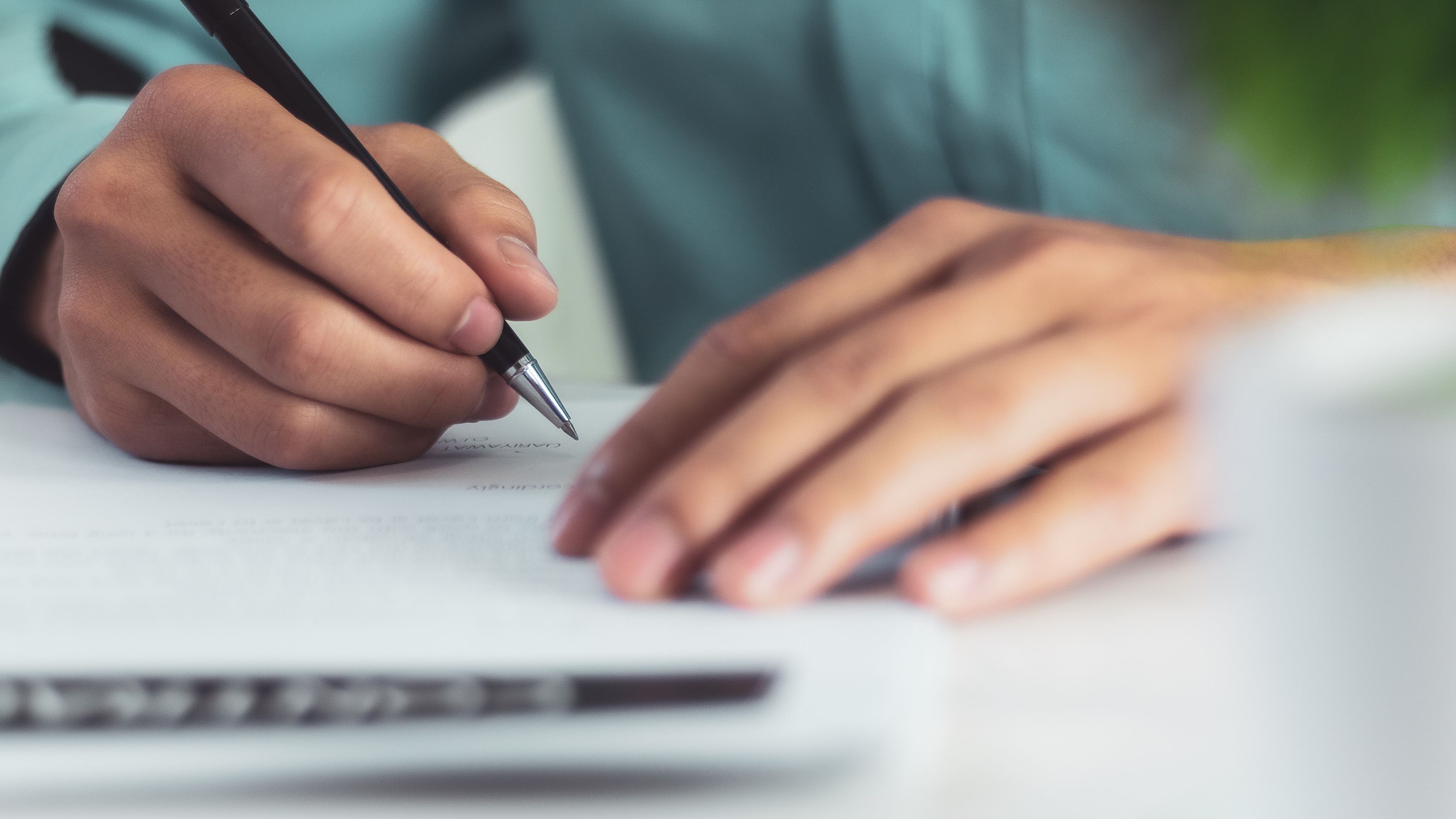 Close-up of person handwriting a letter to their MP
