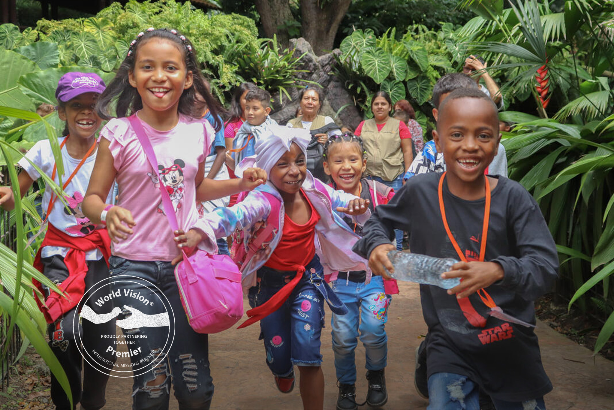A group of sponsored children in Columbia run towards the camera