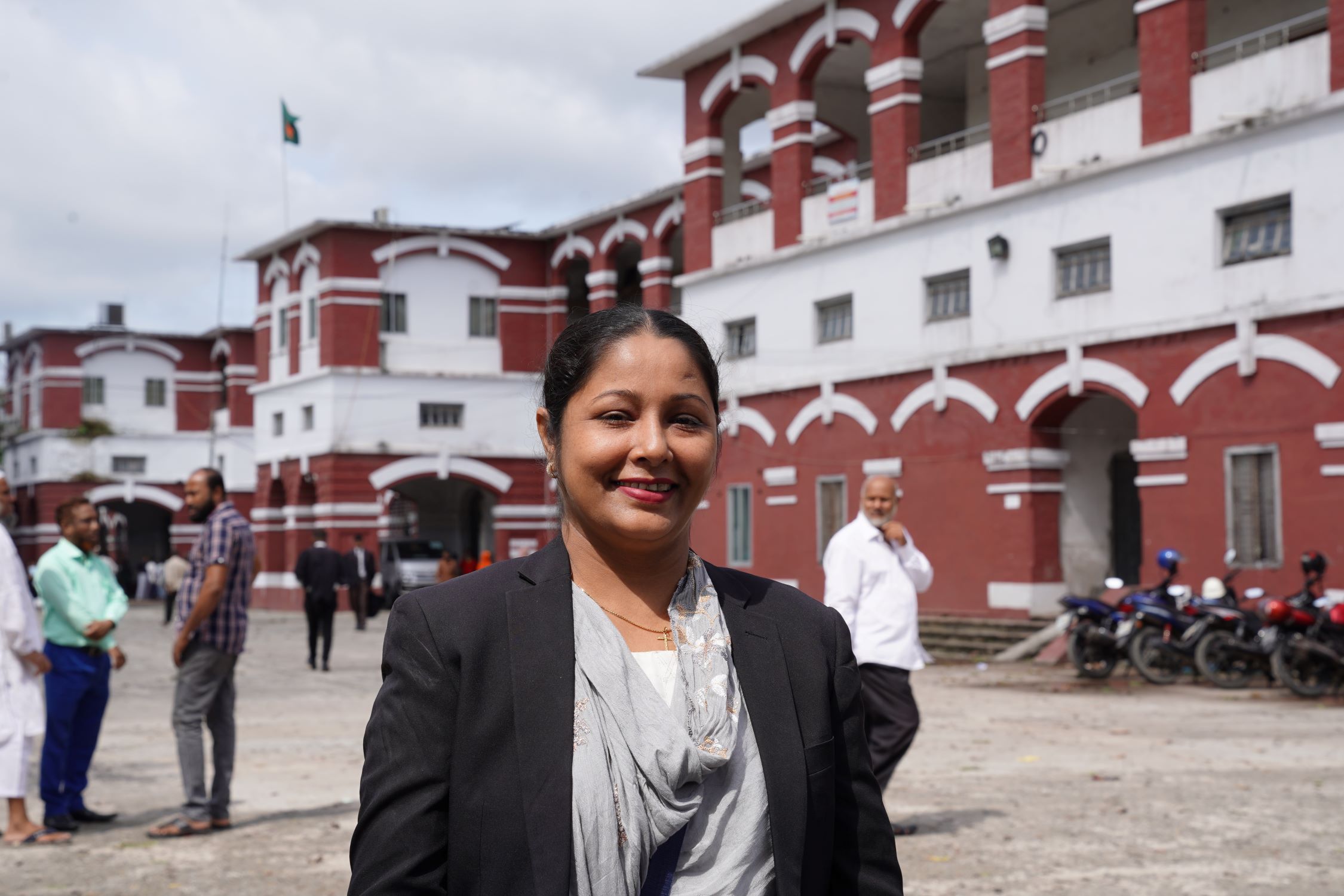 Female lawyer from Bangladesh smiling at the camera, once a sponsored child