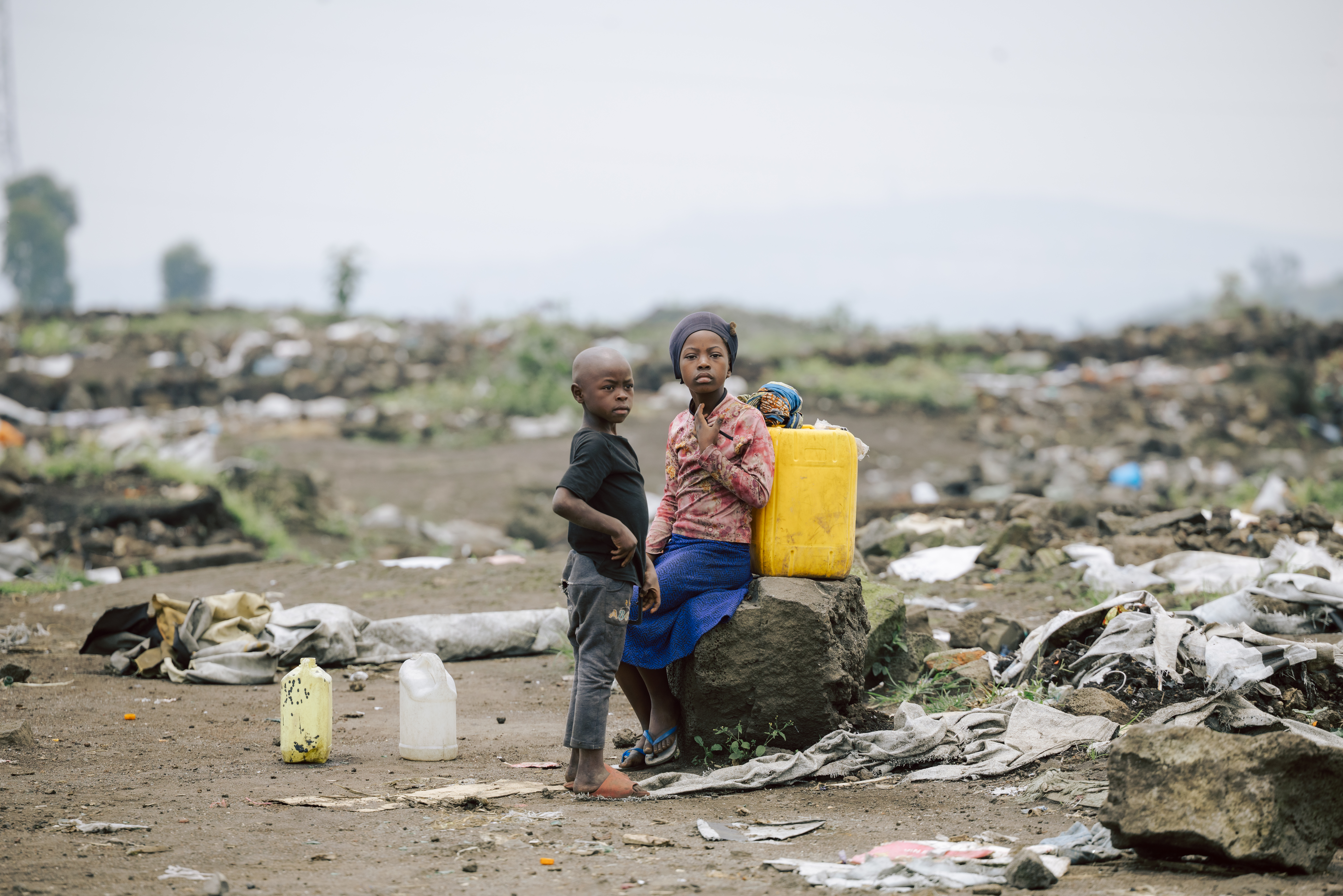 Children sit amidst rubbish in the DRC